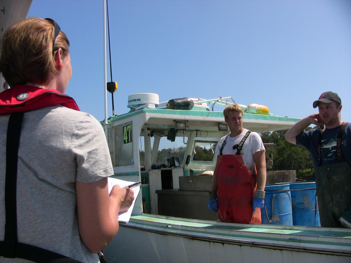 Photo of Mary Davis interviewing lobstermen.