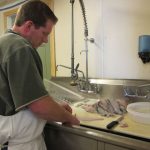 Jamie Johnson filets a sole.