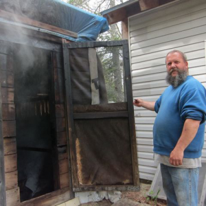 a man standing at the door of a smoker.