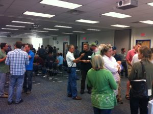 a room full of people mingling in small groups