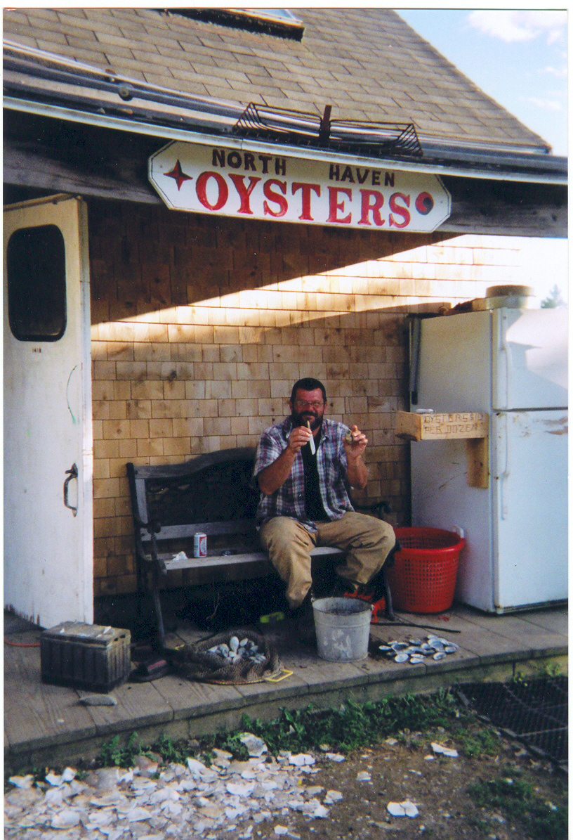 photo of a customer in front of the North Haven Oyster Company storefront