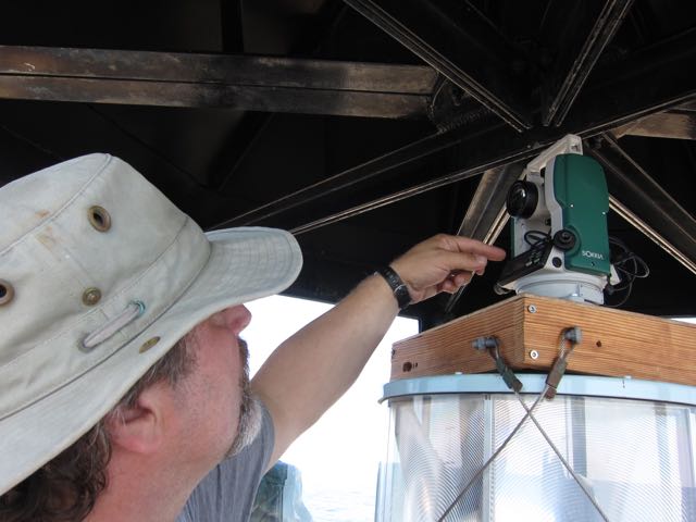 Sean Todd points to the theodolite instrument in the light tower