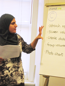 a woman standing before a flipchart