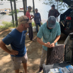 two people building seed cages for hard clams