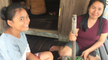 featured image two smiling women processing food