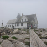 House in fog on granite ledge, foggy background