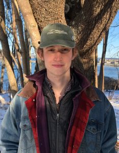 Wriley Hodge standing in front of a tree in wintertime
