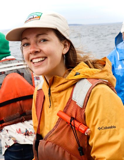 Allie Ouimet in a boat water in the background